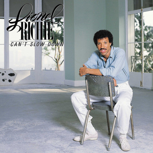 Album cover featuring a man sitting on a chair with ' Lionel Richie Can't Slow Down' text.